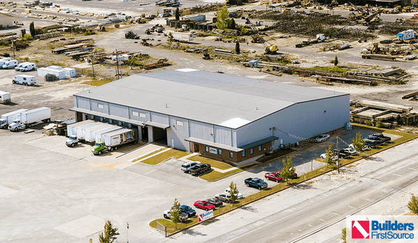 Building materials supplier Builders FirstSource's forklift is moving wood roof trusses.