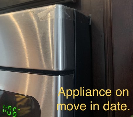 Microwave appliance taped on move in date.