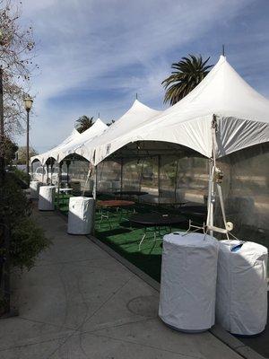 15' x 60' festival style canopy / tent with clear sidewall, astro turf flooring.