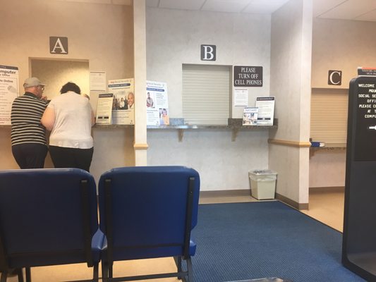 Two of 3 windows closed while the waiting area was almost full.