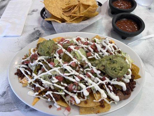 Nachos supreme with chorizo and hot salsa! Epic and delicious!