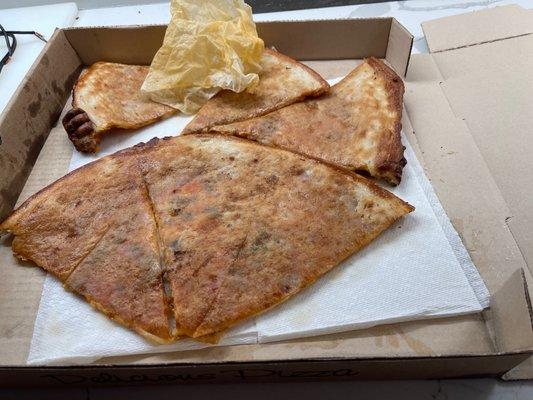 Underside of pizza saturated in grease.