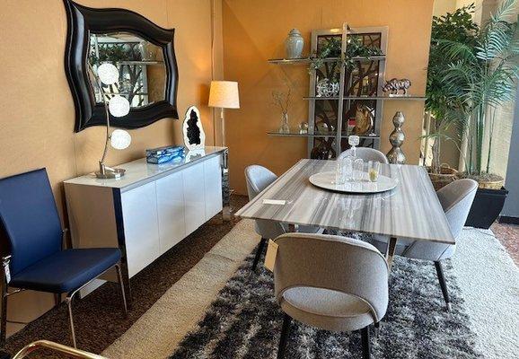 Porcelain Dining table with upholstered dining chairs. Accented with a lacquer white buffet and mirrored etagere by Johnston Casual.