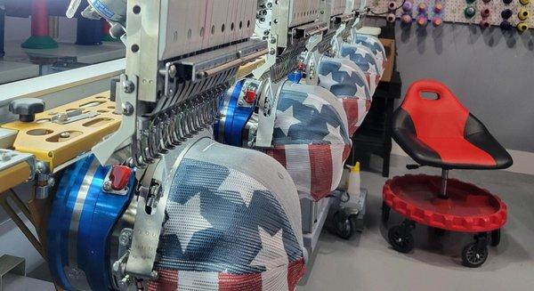 Hat embroidery machine stitching mesh trucker hats.