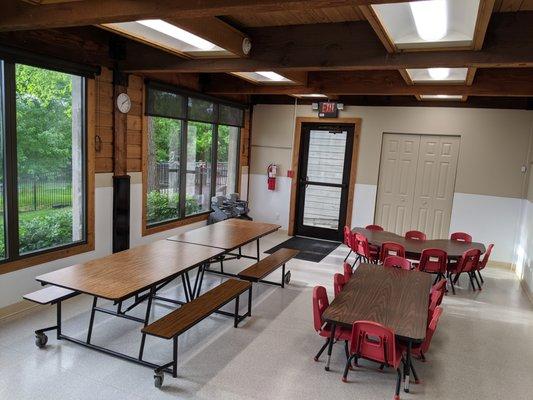 Another view of our cafeteria with a well-stocked art pantry plus entry to the play area.