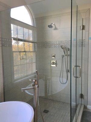 Custom tiled shower with custom frame-less glass doors