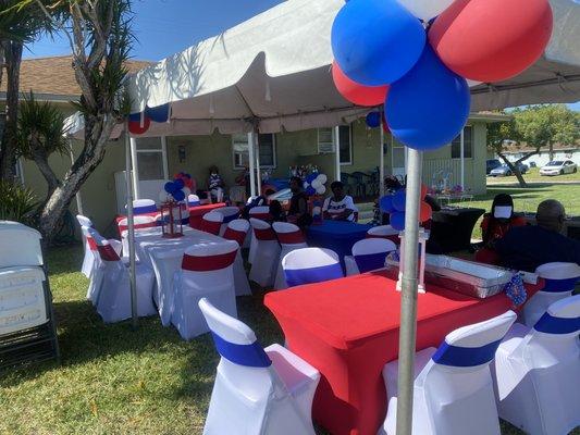 Tent tables and chairs decorated for memorial day party