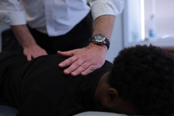 Treating a patient for back pain from a recent car accident at our Worcester office.