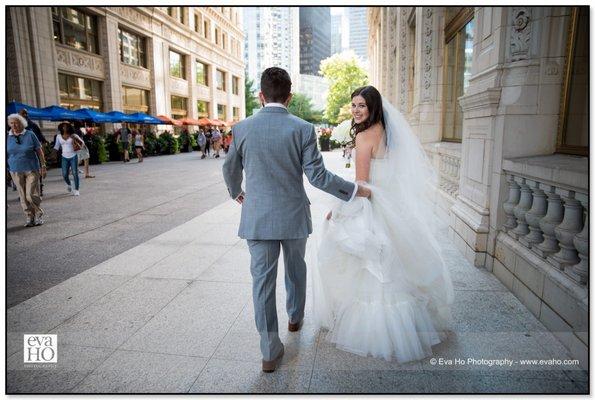 Bride and Groom walking down a busy Chicago street just next to the Magnificent Mile.