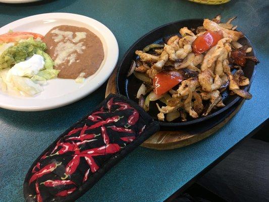 Chicken fajitas and plate of sides