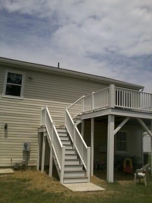 Demoed & rebuilt this 2nd story deck. All pressure treated material covered with white PVC material with grey composite decki...