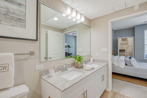 a bathroom with two sinks and a large mirror