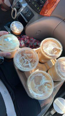 On lap: Sweet cream cold brew, 2 vanilla lattes & a white mocha - holding brown sugar espresso & Carmel macchiato