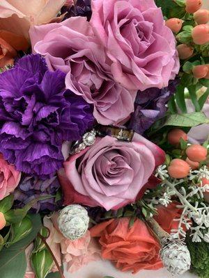 Our rings in my bouquet next to the single carnation placed for my now husbands late mom.