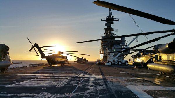 The sun rises over a ship during the Rim of the Pacific excersize.