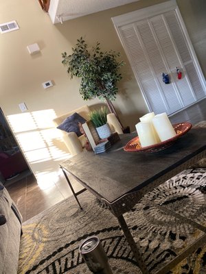 The sun shines on my amazing YELLOW chair as it sits in front of my steel and wood coffee table.