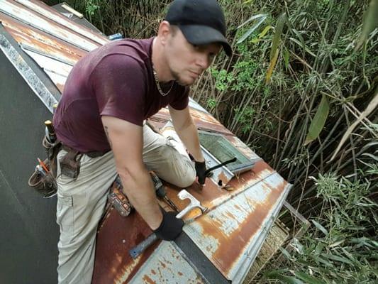 Installing reclaimed metal on customers treehouse