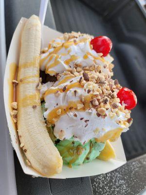 Banana split with a scoop of mint chip ice cream and a scoop of chocolate ice cream.