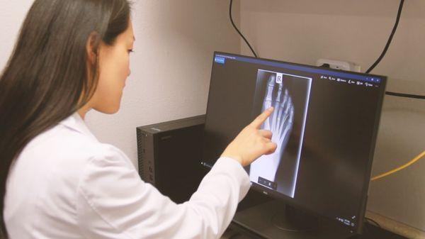 Dr. Joyce examining an x-ray to provide a patient with a pain solution.