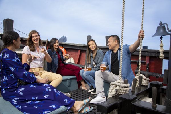 Passengers enjoying a local craft beer underway.