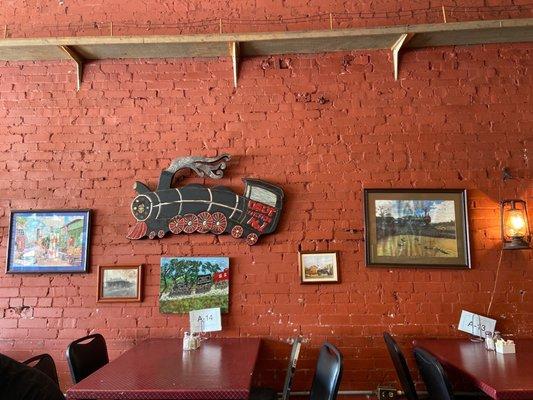 One wall of dining area. Just so cute filled with various train pictures and framed puzzles - trains everywhere!