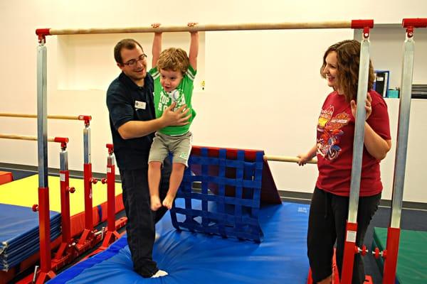 Ian assists a young gymnast in the Toddler 2 class.