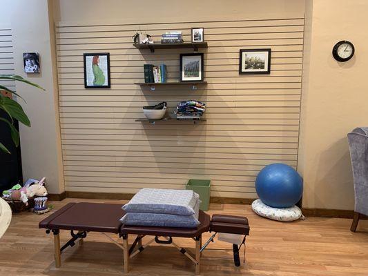 Adjusting table, kids toys, breastfeeding pillow and exercise ball. Perfect space for a growing family.