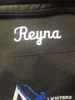 Name on her bag. He aligned it perfectly with the team name.