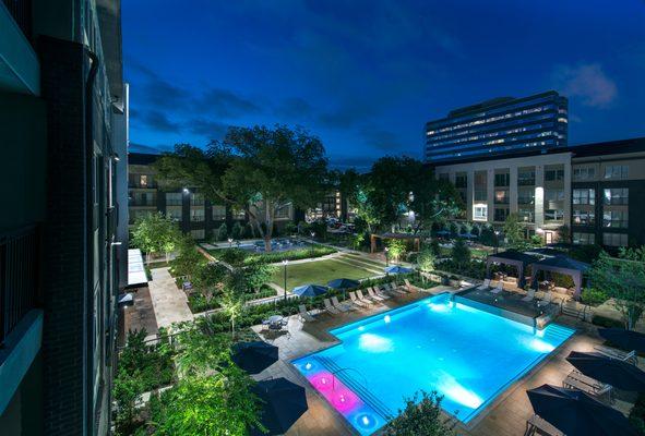 Resort-style pool courtyard with pool side cabanas and outdoor dining and grilling areas