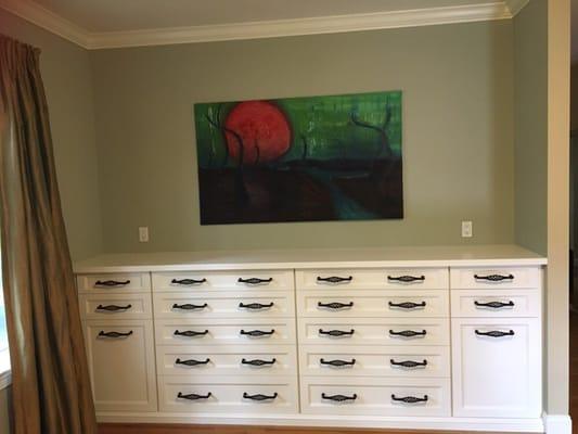 Custom built-in dresser with hampers.