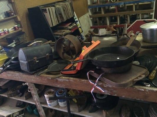 Cast iron, jars, pots and pans, and tools/hardware.