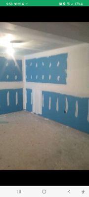 Finished basement walls before texture or sanding.