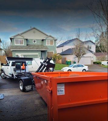 Positioning the dump container so it can properly be loaded onto the back of the truck. Transportation-ready!