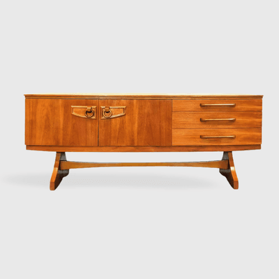 Beautility UK vintage teak bow front credenza on trestle base.