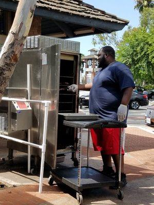 The "man" pulling ribs from the smoker