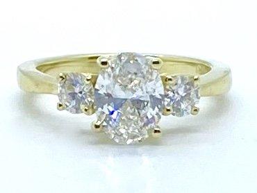 18kt yellow gold Oval diamond with round side stones.