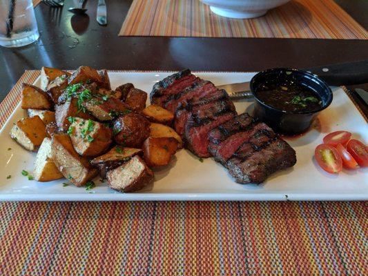 Flank steak with roasted potatoes and chimichurri.