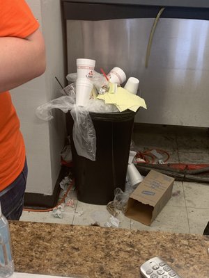 The trash can at the front checkout counter.