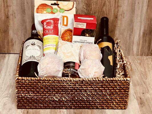 A delightful gourmet basket with two beautiful bottles of wine