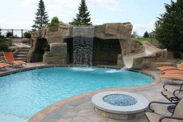 Pool, waterfall, slide, fire pit, grotto and swim up bar.