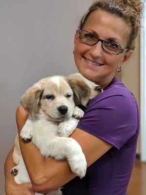 The clinic manager loving on the rescue pups