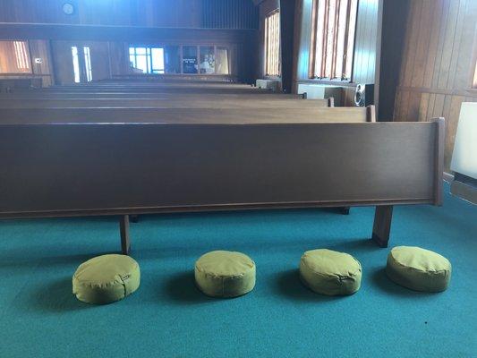 Meditation pillows provide an alternative to traditional pew seating.