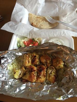 Chicken kabob with rice and a small salad