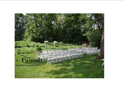 White chairs...so elegant for an out door ceremony. Call us 319-366-8291