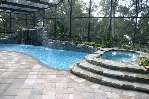 Beautiful Rockwork on this grotto Pool with flagstone coping! We in-laid a secret lair under the waterfall!...