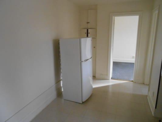 Kitchen. New refrigerator. Vinyl tile floor waxed.