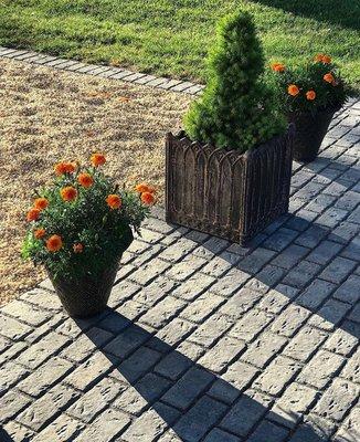 Pavers meet beach pebble stone driveway.