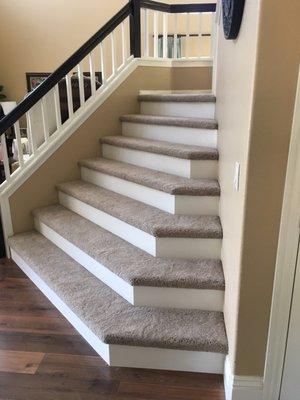 Carpeted angled stairs with custom risers.