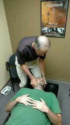 Dr. Gander manually adjusts a patient's neck.