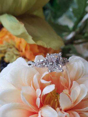 Traditional style engagement ring with a radiant cut diamond set in 14k white gold